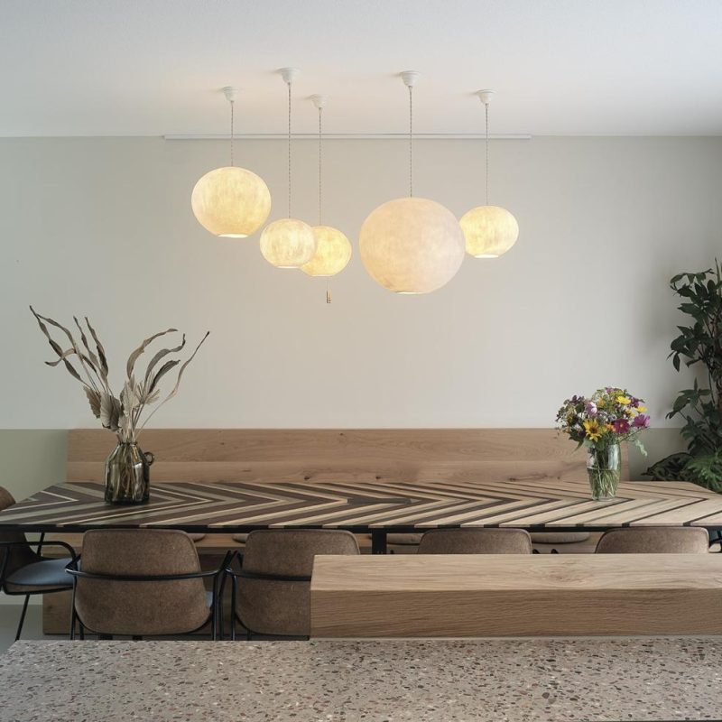 Handgemaakte biobased eettafel en houten zitbank in modern wooninterieur.